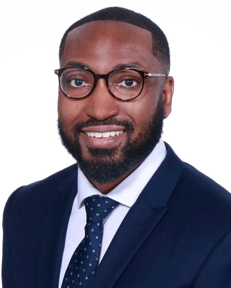 corporate headshot man navy suit glasses white shirt patterned blue tie