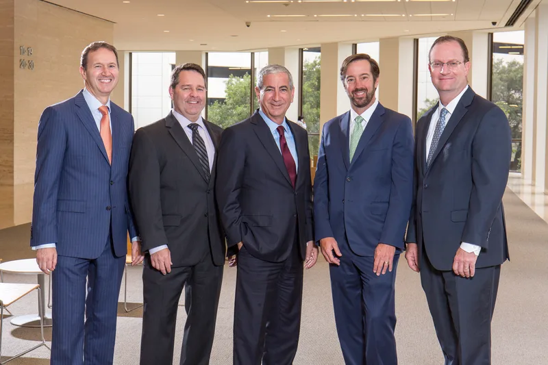 Corporate group headshot five men in navy and charcoal business suits