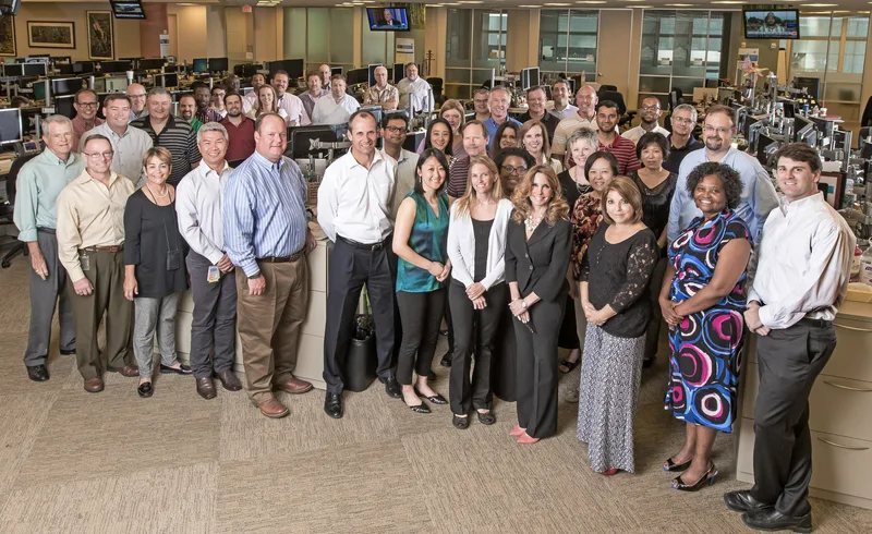 Large corporate team group headshot professionals gathered in open office environment