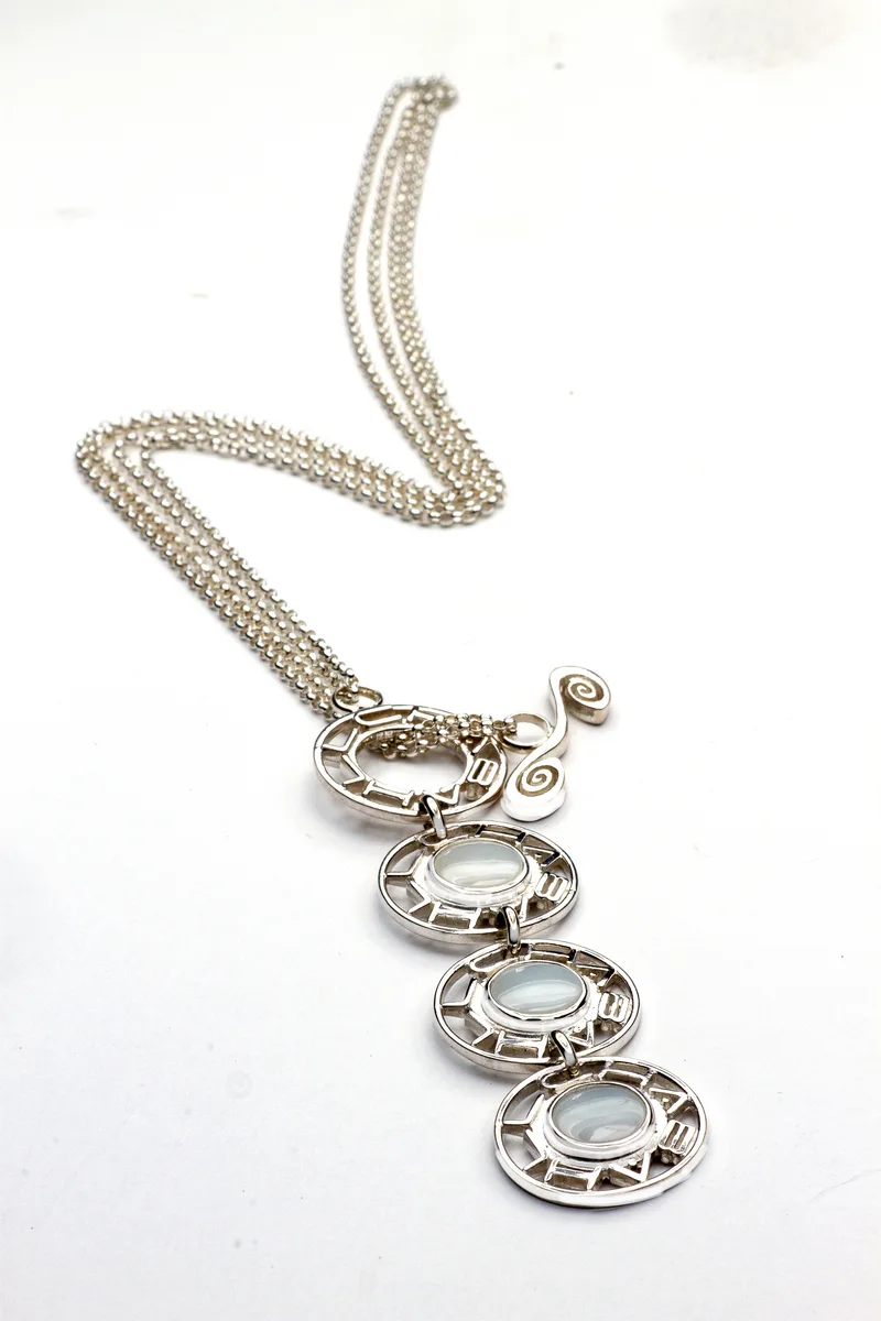 jewelry photography silver necklace three lattice medallions oval cabochon stones scroll accent