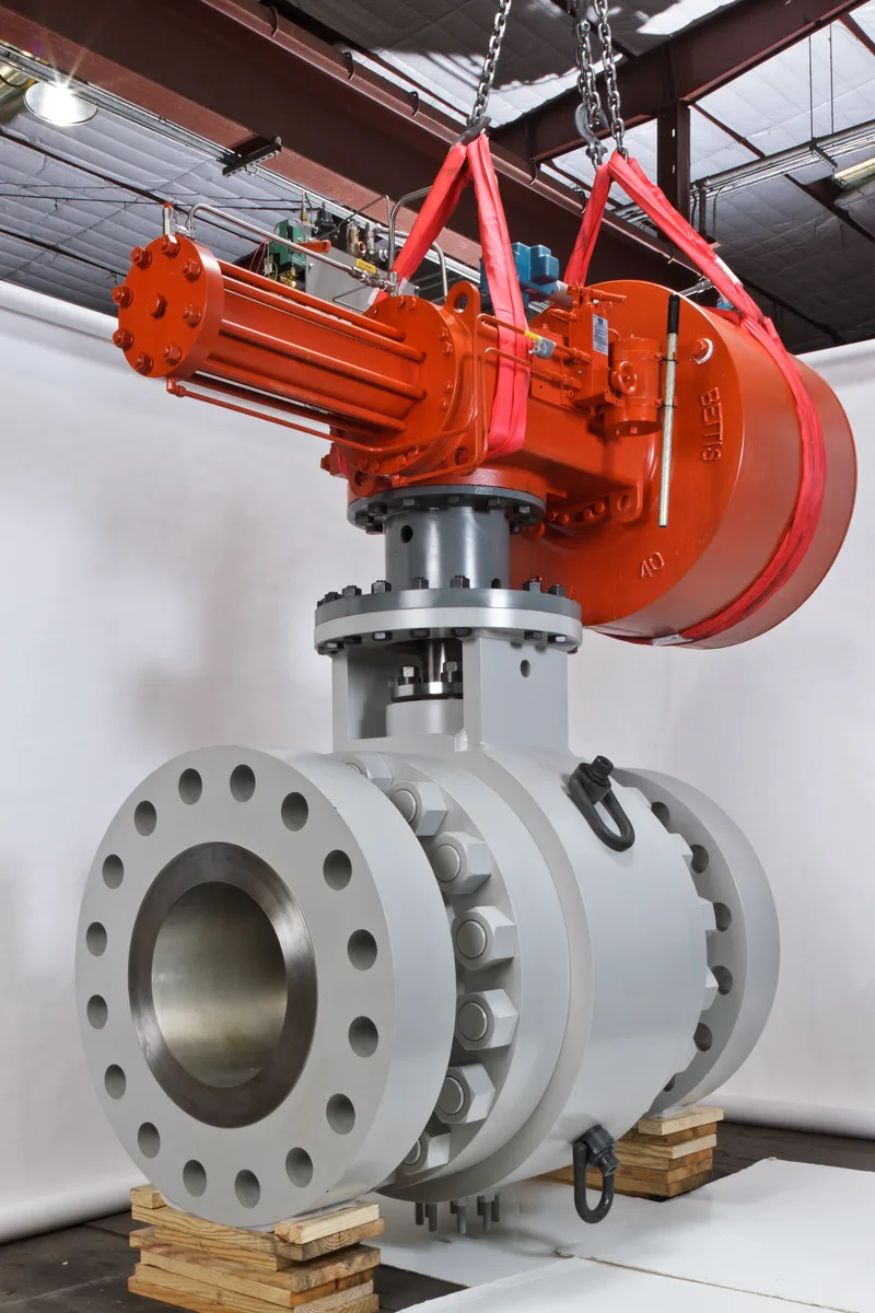 FlexStream 24DS286 trunnion ball valve with orange pneumatic actuator suspended by chains